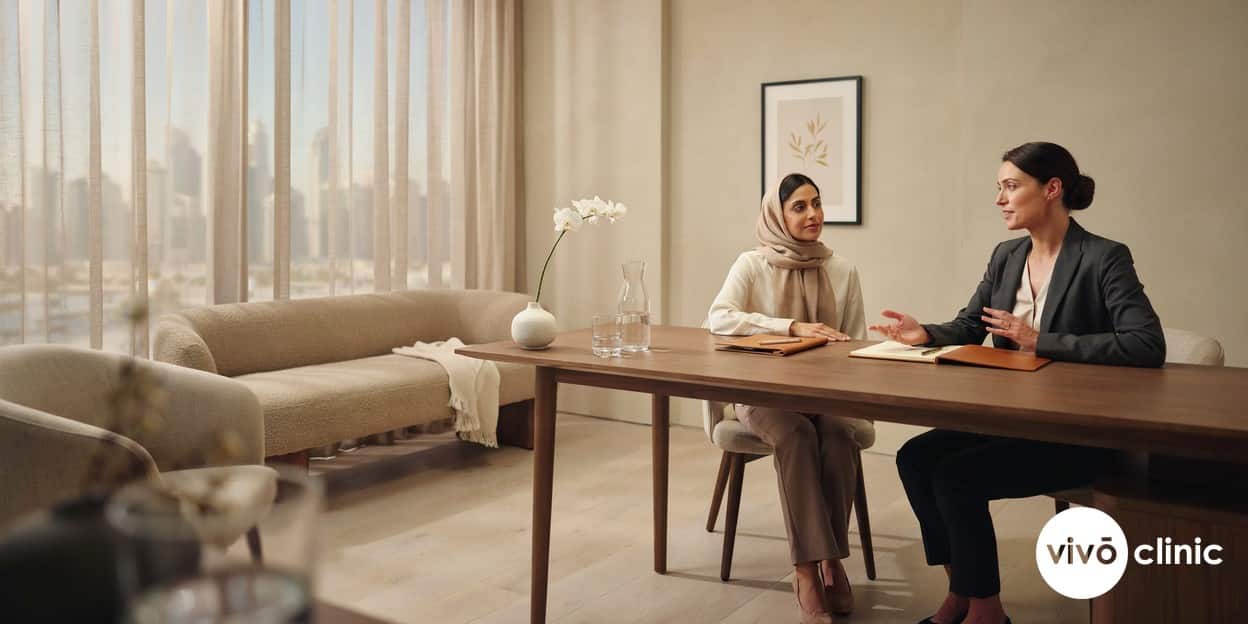Middle Eastern woman in modest dress speaking with a female practitioner during a confidential HIFU consultation for stress urinary incontinence at VIVO Clinic Dubai