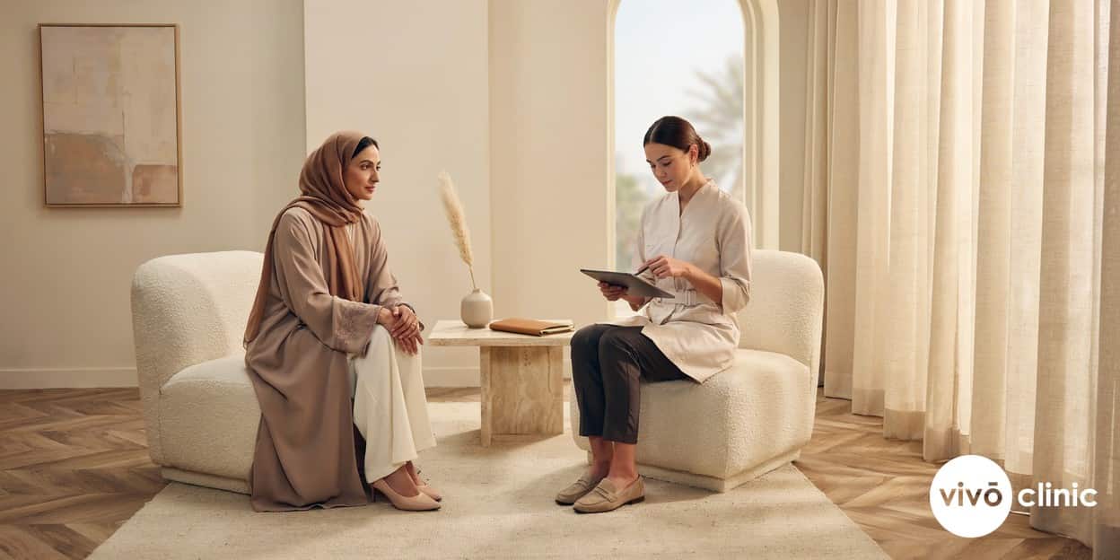 Middle Eastern woman in modest attire speaking with a female practitioner during a confidential HIFU vaginal tightening consultation about long-term results at VIVO Clinic Dubai