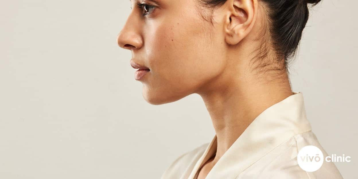 Photorealistic close-up of a Middle Eastern woman’s firm, well-defined jawline and neck in profile, soft natural studio light, no device, machine or handpiece anywhere in frame