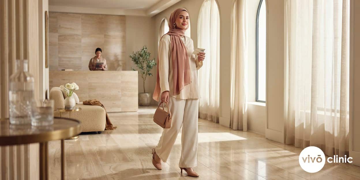 Middle Eastern woman in modest dress smiling calmly as she leaves a HIFU facelift appointment, looking relaxed and at ease, illustrating the minimal downtime after treatment at VIVO Clinic Dubai