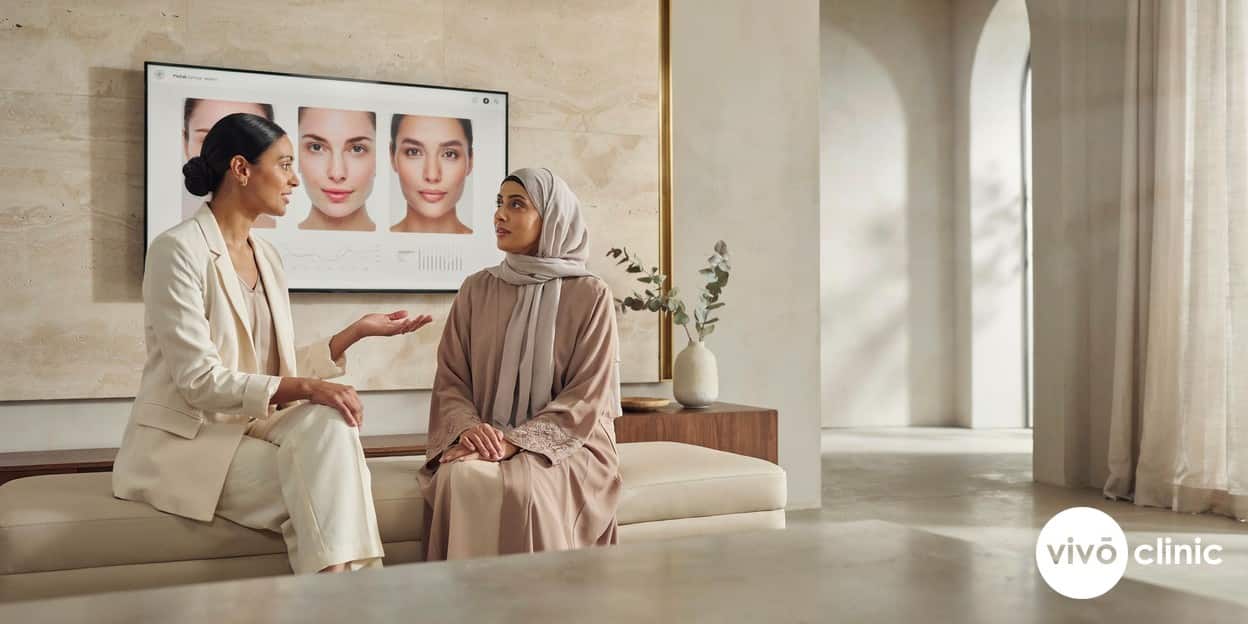 Middle Eastern practitioner and patient reviewing clinical research and before-and-after data together on a screen during an evidence-led consultation at VIVO Clinic Dubai