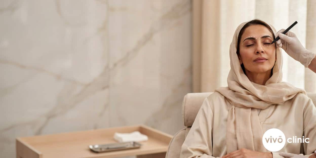 Middle Eastern woman with fine white cosmetic marking dots mapped along her upper eyelid during a plasma eye lift consultation at VIVO Clinic Dubai