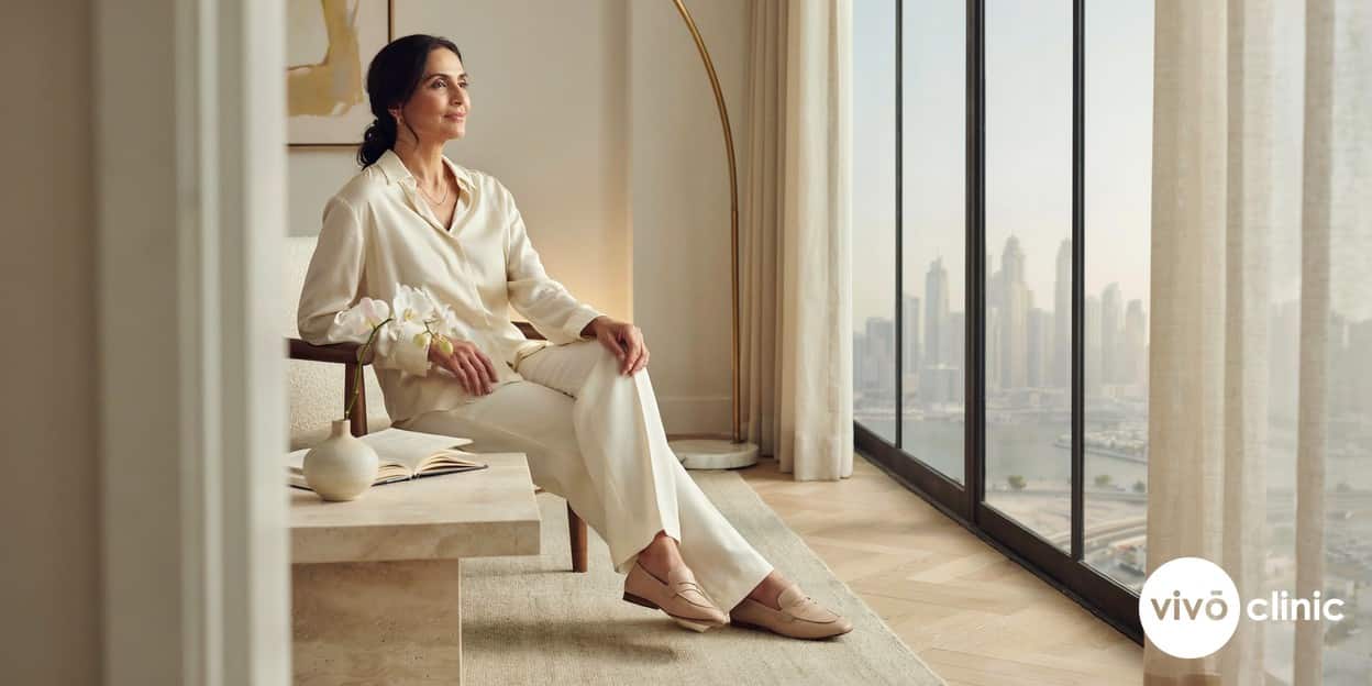 Middle Eastern woman in her forties with healthy, firm skin smiling confidently in soft natural light in an elegant Dubai home, illustrating an ideal HIFU skin tightening candidate with good skin quality